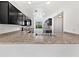 Modern kitchen with black cabinets, stainless steel appliances, and a sink overlooking the backyard at 1953 W Stage Driver St, Apache Junction, AZ 85120
