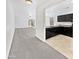 Open concept kitchen with black cabinetry, sleek appliances seamlessly transitions into living and dining spaces at 1953 W Stage Driver St, Apache Junction, AZ 85120