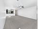 A view of a large and bright open living area with neutral carpet and seamless transition to the kitchen at 1953 W Stage Driver St, Apache Junction, AZ 85120