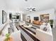 Bright living room with stylish furniture, modern ceiling fan, and open layout flowing into kitchen and dining areas at 1953 W Stage Driver St, Apache Junction, AZ 85120