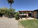 A pergola stands on a concrete pad surrounded by green grass, rock, and foliage, a tranquil outdoor retreat at 2325 E Osborn Rd, Phoenix, AZ 85016