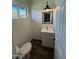 Charming half-bathroom with geometric accent wall, modern vanity, and wood-look floors at 2325 E Osborn Rd, Phoenix, AZ 85016