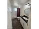 Updated bathroom features a modern vanity, stylish mirror, and tub with decorative shower curtain at 2325 E Osborn Rd, Phoenix, AZ 85016