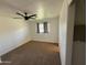 Bright bedroom with neutral carpet, a ceiling fan, and a sun-filled window at 2325 E Osborn Rd, Phoenix, AZ 85016
