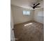 A comfortable bedroom features neutral carpet, a ceiling fan, and sunny windows for natural light at 2325 E Osborn Rd, Phoenix, AZ 85016