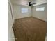A cozy bedroom with neutral carpet, ceiling fan, and bright windows offers a relaxing space at 2325 E Osborn Rd, Phoenix, AZ 85016
