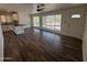 Spacious living room with updated flooring, plenty of natural light, and a view of the kitchen at 2325 E Osborn Rd, Phoenix, AZ 85016