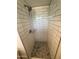 A shower with sleek subway tile and a pebble floor offers a spa-like experience at 2325 E Osborn Rd, Phoenix, AZ 85016