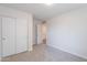 Bedroom with plush carpet, view to hallway and sliding door closet at 23852 W La Salle St, Buckeye, AZ 85326