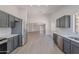 Spacious kitchen with stainless steel appliances, light countertops, gray cabinets, and an eat-in area at 23852 W La Salle St, Buckeye, AZ 85326