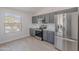 Bright kitchen featuring stainless steel appliances, granite countertops, gray cabinets, and wood-look floors at 23852 W La Salle St, Buckeye, AZ 85326
