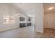 Open-concept space features bright paint, high ceilings, a modern light fixture, and access to kitchen at 23852 W La Salle St, Buckeye, AZ 85326