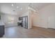 Kitchen with stainless steel appliances, modern light fixture, bright paint, and open access to living spaces at 23852 W La Salle St, Buckeye, AZ 85326