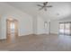 Bright and spacious living room features high ceilings, bright paint, and sliding door access to backyard at 23852 W La Salle St, Buckeye, AZ 85326