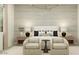 A relaxing main bedroom features neutral colors, soft lighting, and cozy furnishings at 25169 N 177Th Dr, Surprise, AZ 85387