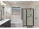 A bright bathroom featuring a vanity, soaking tub and sleek glass-door shower at 3326 N 31St St, Mesa, AZ 85213