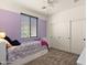Bedroom with a purple accent wall, plush carpet, and modern sliding closet doors, creating a cozy retreat at 3326 N 31St St, Mesa, AZ 85213