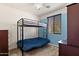 A simple and clean room features plush carpets, a bunk bed, and light blue accent walls at 3326 N 31St St, Mesa, AZ 85213
