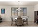 Inviting dining area featuring a modern chandelier, sleek furniture, and lots of light at 3326 N 31St St, Mesa, AZ 85213