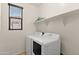 Compact laundry room featuring essential appliances and a useful shelf for storage convenience at 3326 N 31St St, Mesa, AZ 85213