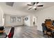 Spacious open-concept living area featuring neutral walls, wood-look flooring, and contemporary ceiling fan at 3326 N 31St St, Mesa, AZ 85213