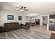 Open-concept living room with ceiling fan leading to dining area and kitchen at 3326 N 31St St, Mesa, AZ 85213