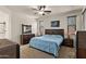 Spacious main bedroom with a ceiling fan, carpeted floors and classic dark wood furniture at 3326 N 31St St, Mesa, AZ 85213