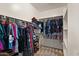 Organized walk-in closet with ample hanging space, shelving, and carpeted flooring at 3326 N 31St St, Mesa, AZ 85213