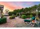 Lush backyard with mature trees, landscaped flower beds, and a tranquil lounge chair at 4046 E Crocus Dr, Phoenix, AZ 85032