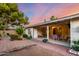 Backyard patio with covered seating area, manicured landscaping, and a serene outdoor dining spot at 4046 E Crocus Dr, Phoenix, AZ 85032
