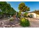 Well-maintained backyard featuring plants, trees and an outdoor area at 4046 E Crocus Dr, Phoenix, AZ 85032