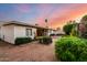 Backyard exterior view with patio, flowering shrubbery, and a clear view of the home's facade at 4046 E Crocus Dr, Phoenix, AZ 85032