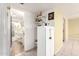 Hallway view leading to a bathroom, featuring a tiled floor, white cabinetry, and a glass shower door at 4046 E Crocus Dr, Phoenix, AZ 85032