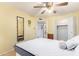 A sunny bedroom features a ceiling fan, mirror, and closet at 4046 E Crocus Dr, Phoenix, AZ 85032