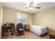 Bedroom with laminate flooring, ceiling fan, and window with blinds at 4046 E Crocus Dr, Phoenix, AZ 85032