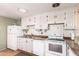 A kitchen featuring white cabinets, appliances, and tile countertops at 4046 E Crocus Dr, Phoenix, AZ 85032