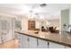 Stylish kitchen island with granite countertop and white cabinets, open to the dining area at 4046 E Crocus Dr, Phoenix, AZ 85032