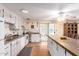 Well-lit kitchen features island, white cabinets, ample counter space and appliances at 4046 E Crocus Dr, Phoenix, AZ 85032