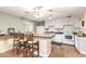 Bright kitchen with wooden bar stools at kitchen island and white appliances at 4046 E Crocus Dr, Phoenix, AZ 85032