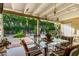 Inviting covered patio overlooking a lush backyard with mature trees and landscaping at 4046 E Crocus Dr, Phoenix, AZ 85032