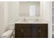 Bathroom with dual sinks, dark wood cabinets, and ample storage below, plus a toilet and fixtures at 4195 W Lisa Ln, San Tan Valley, AZ 85144