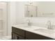 Bathroom with dual sinks, a large mirror, and a shower showcasing a modern design and functionality at 4195 W Lisa Ln, San Tan Valley, AZ 85144