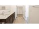 Double sink bathroom with wood cabinets, a tile floor, and modern fixtures in a neutral color palette at 4195 W Lisa Ln, San Tan Valley, AZ 85144