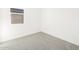 Empty bedroom with light gray carpet and a window providing natural light at 4195 W Lisa Ln, San Tan Valley, AZ 85144