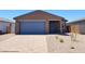 Charming single-story home featuring a blue garage door and modern architectural details at 4195 W Lisa Ln, San Tan Valley, AZ 85144