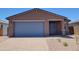 Charming single-story home featuring a blue garage door and modern architectural details at 4195 W Lisa Ln, San Tan Valley, AZ 85144
