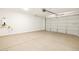 Spacious, empty garage featuring a water heater and a paneled garage door at 4195 W Lisa Ln, San Tan Valley, AZ 85144