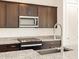 Close-up shot of modern kitchen with stainless steel microwave and granite countertops at 4195 W Lisa Ln, San Tan Valley, AZ 85144