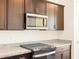 Close-up shot of modern kitchen with stainless steel microwave and granite countertops at 4195 W Lisa Ln, San Tan Valley, AZ 85144