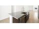 Modern kitchen features a stainless steel sink, granite countertops, and dark cabinets at 4195 W Lisa Ln, San Tan Valley, AZ 85144